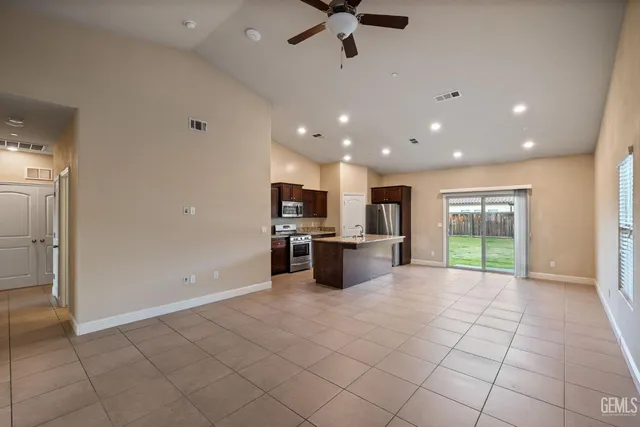 a kitchen with stainless steel appliances a refrigerator and microwave