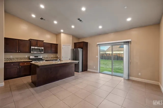 a large kitchen with stainless steel appliances lots of counter top space