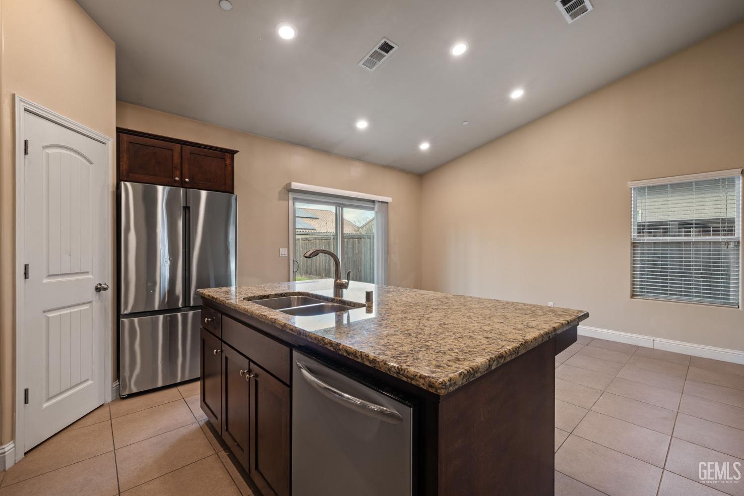 Undisclosed Address Shafter, CA 93263 - Photo 27 of 50 a kitchen with stainless steel appliances granite countertop a sink and a refrigerator