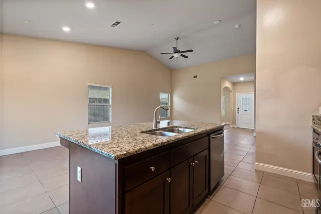 a bathroom with a granite countertop sink a toilet and a mirror