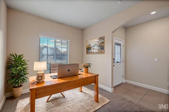 a workspace with furniture and a potted plant