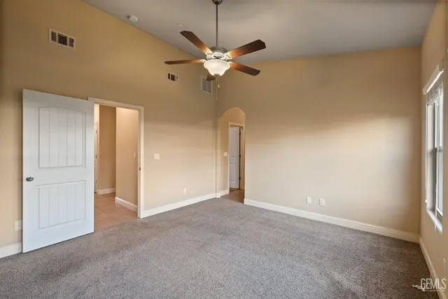 a view of a room with a ceiling fan and a window