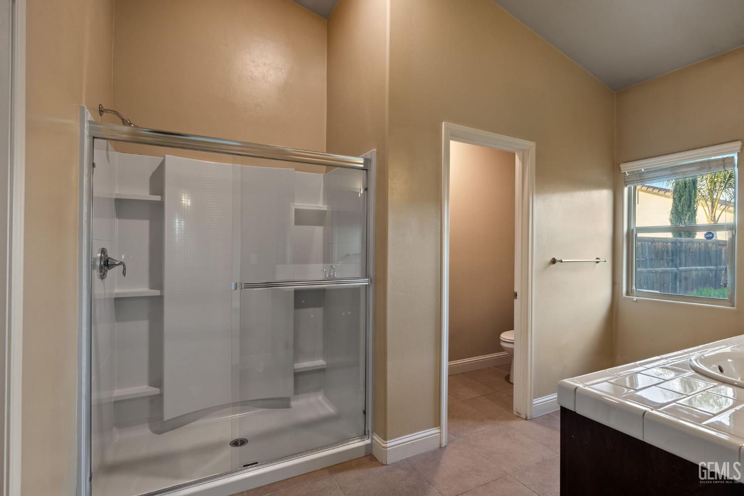 Undisclosed Address Shafter, CA 93263 - Photo 34 of 50 a bathroom with a shower sink and mirror