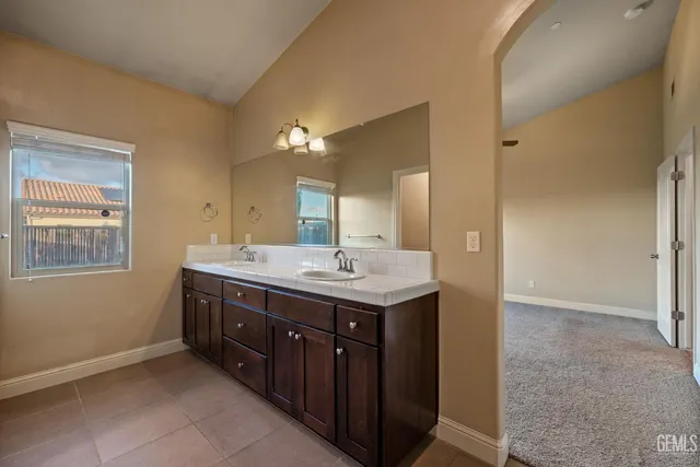 a bathroom with a granite countertop sink a large mirror and a