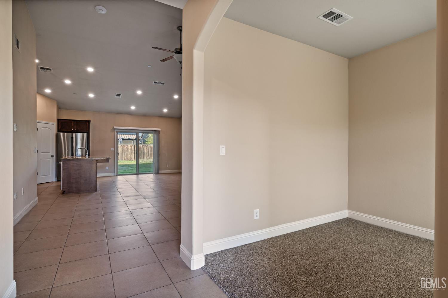 Undisclosed Address Shafter, CA 93263 - Photo 9 of 50 an empty room with a kitchen space and windows