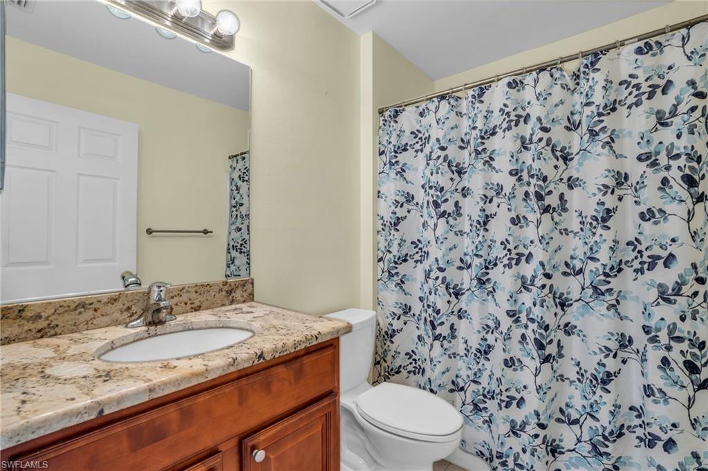 18447 Fuchsia Road Fort Myers, FL 33967 - Photo 21 of 43 a bathroom with a granite countertop sink and a mirror