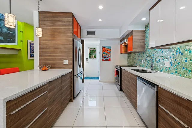 a kitchen with stainless steel appliances granite countertop a sink and a stove