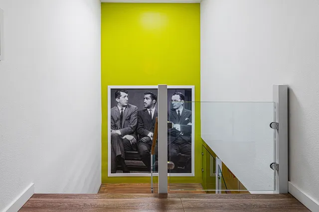 a spacious bedroom with a bed and a chair