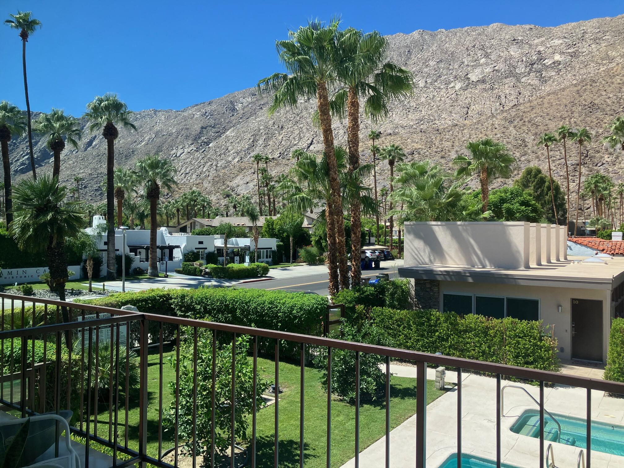 500 West Arenas Road, Unit 2 Palm Springs, CA 92262 - Photo 27 of 36 a view of a house with large trees and a small yard