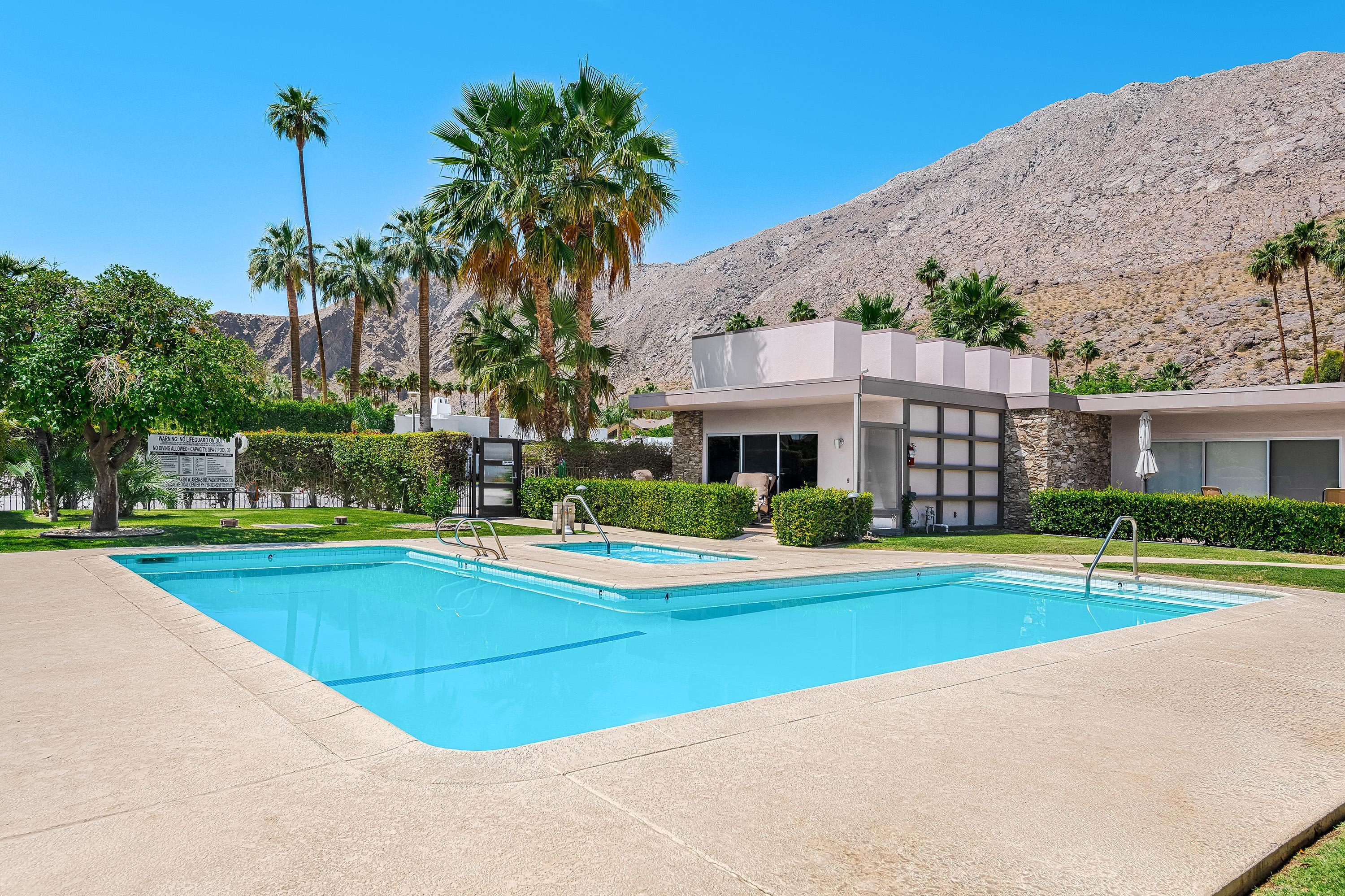 500 West Arenas Road, Unit 2 Palm Springs, CA 92262 - Photo 33 of 36 a view of big white house with a swimming pool and a yard