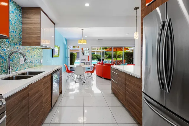 a kitchen with stainless steel appliances granite countertop sink stove top oven and cabinets