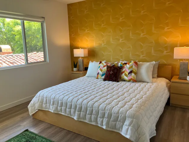 a bedroom with a bed and a window