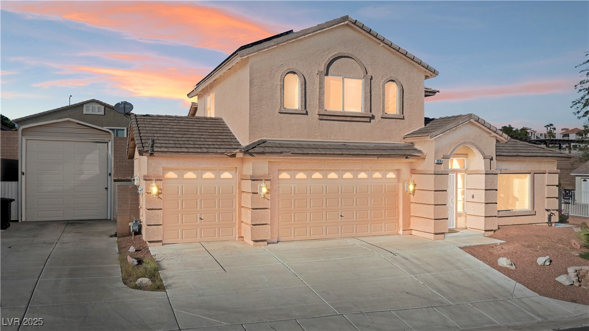 Stylish home featuring a tile roof and concrete driveway
