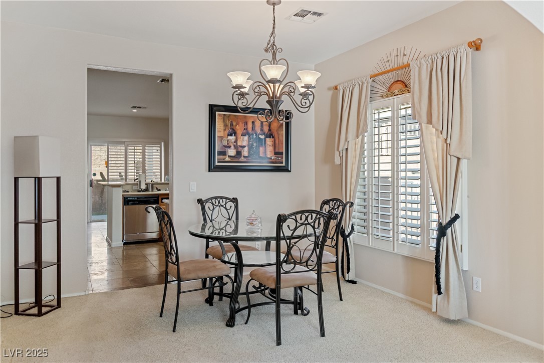 2078 Willow Bay Road Laughlin, NV 89029 - Photo 11 of 99 Dining area featuring light colored carpet and a chandelier