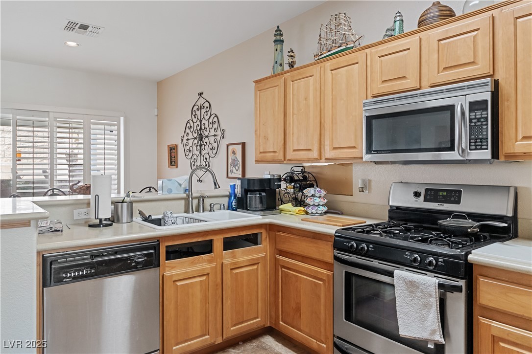 2078 Willow Bay Road Laughlin, NV 89029 - Photo 15 of 99 Kitchen featuring stainless steel appliances, light countertops, a peninsula, and recessed lighting