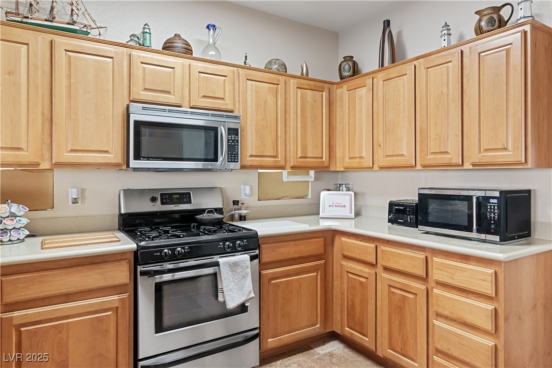 2078 Willow Bay Road Laughlin, NV 89029 - Photo 16 of 99 Kitchen with stainless steel appliances and light countertops