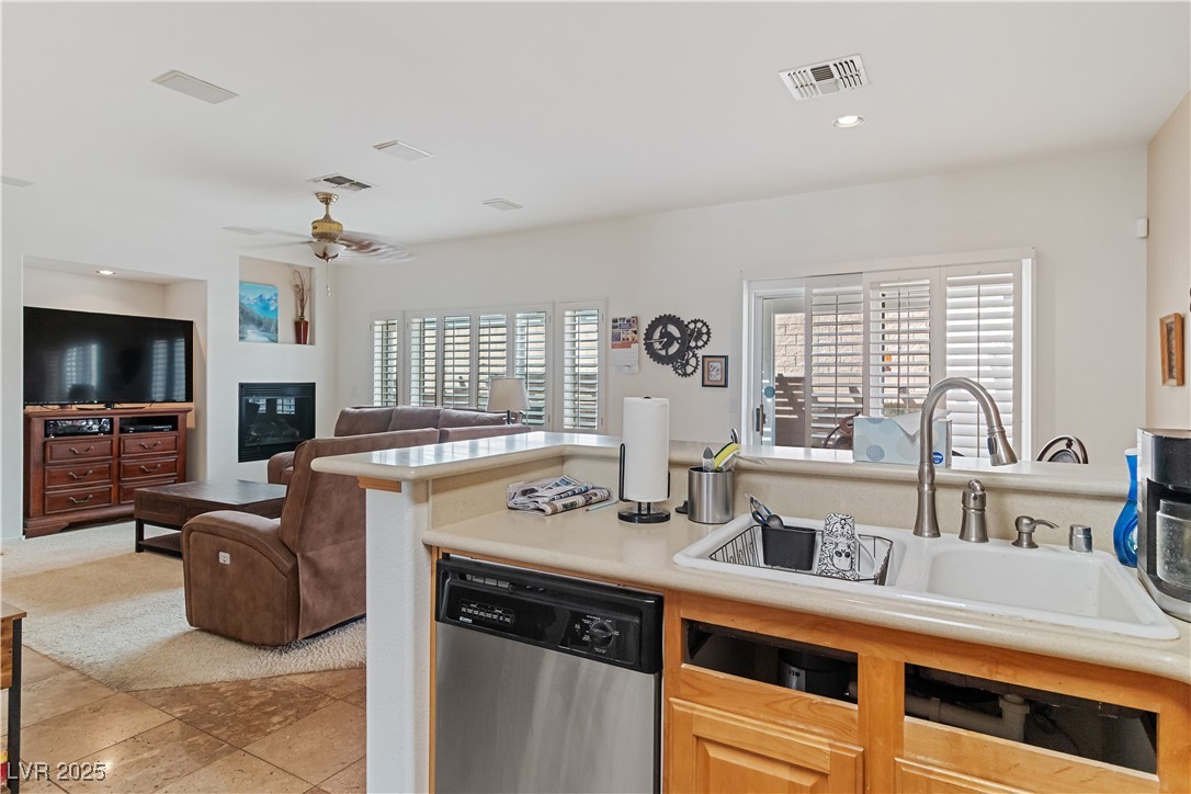 2078 Willow Bay Road Laughlin, NV 89029 - Photo 99 of 99 Kitchen with light countertops, stainless steel dishwasher, recessed lighting, a glass covered fireplace, and open floor plan