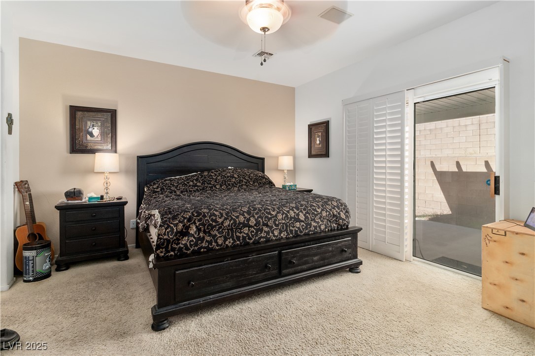 2078 Willow Bay Road Laughlin, NV 89029 - Photo 32 of 99 Carpeted Primary Bedroom with access to outside and ceiling fan
