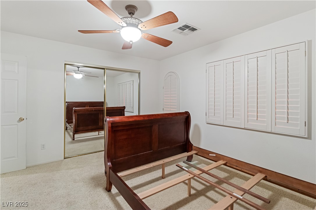 2078 Willow Bay Road Laughlin, NV 89029 - Photo 46 of 99 Second Bedroom featuring a ceiling fan, light carpet, and a closet