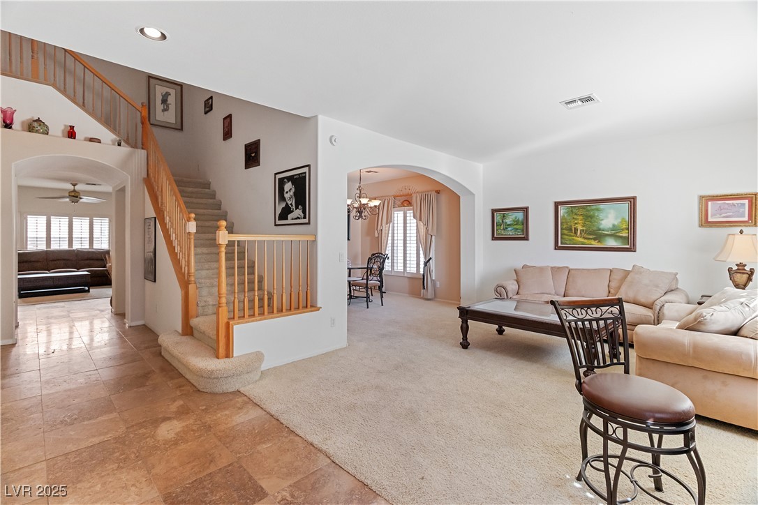 2078 Willow Bay Road Laughlin, NV 89029 - Photo 5 of 99 Living area with stairway, arched walkways, healthy amount of natural light, light colored carpet, and recessed lighting
