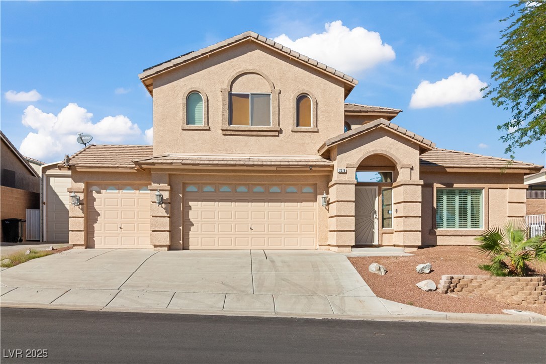 2078 Willow Bay Road Laughlin, NV 89029 - Photo 59 of 99 Mediterranean / spanish-style home with stucco exterior, a tiled roof, driveway, and an attached garage