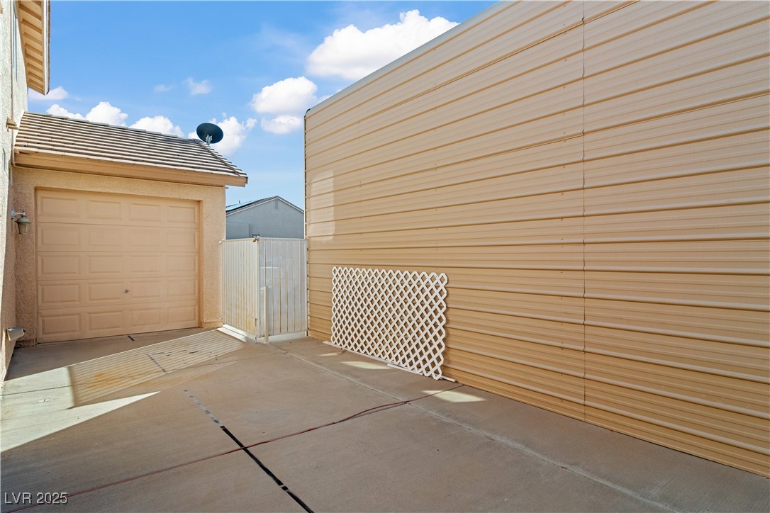 2078 Willow Bay Road Laughlin, NV 89029 - Photo 65 of 99 View from the backyard of the pull-through bay in the 3 car garage, with the fully enclosed permitted RV structure with hookups and dump station