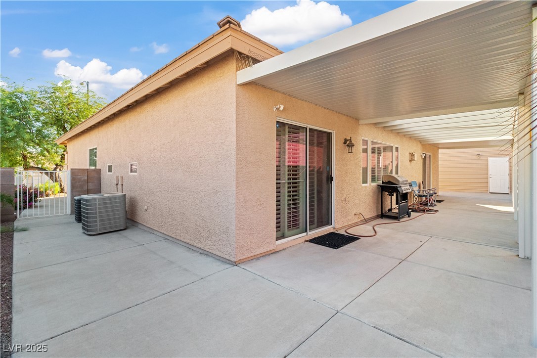 2078 Willow Bay Road Laughlin, NV 89029 - Photo 75 of 99 View of side of property with stucco siding, a patio, and a gate