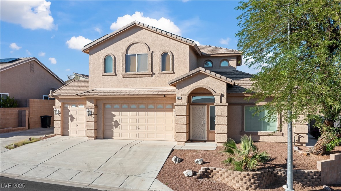 2078 Willow Bay Road Laughlin, NV 89029 - Photo 82 of 99 Mediterranean / spanish-style house featuring stucco siding, driveway, a tiled roof, and an attached garage