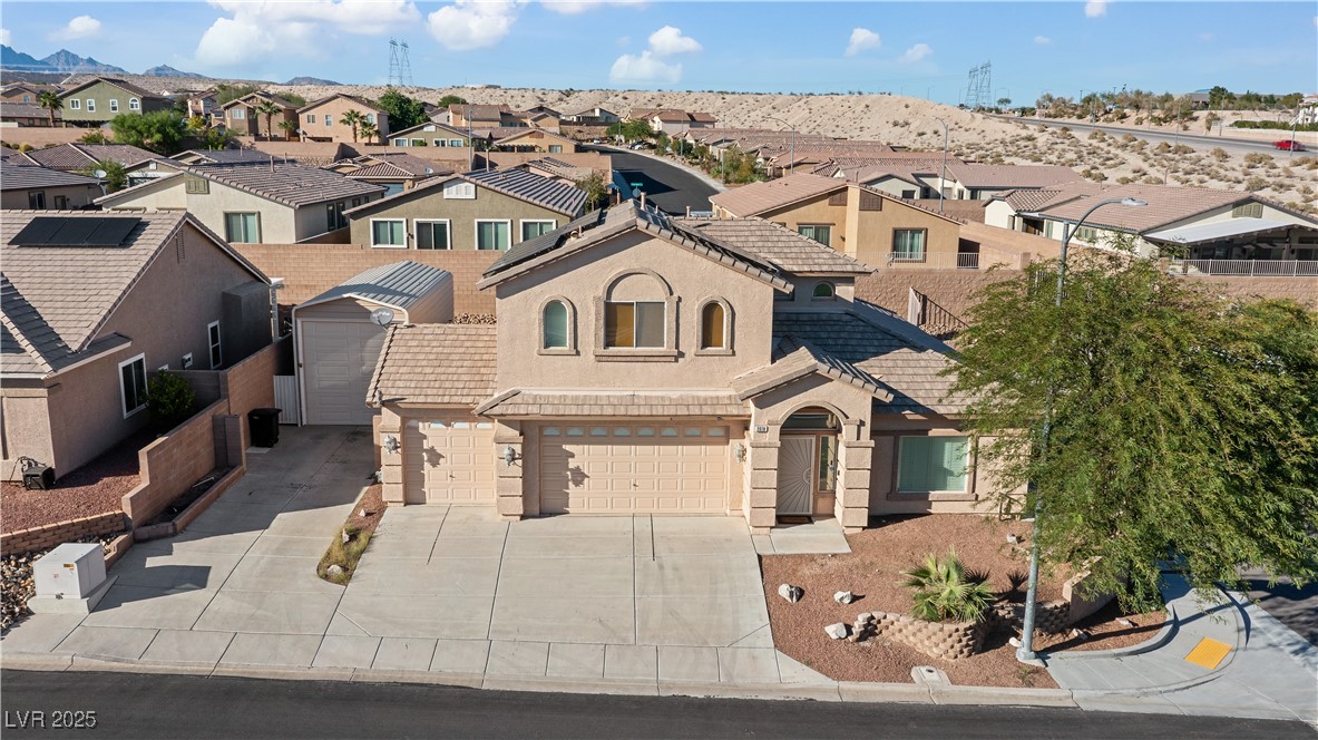 2078 Willow Bay Road Laughlin, NV 89029 - Photo 92 of 99 Mediterranean / spanish home featuring a residential view, stucco siding, driveway, an attached garage, and a tiled roof