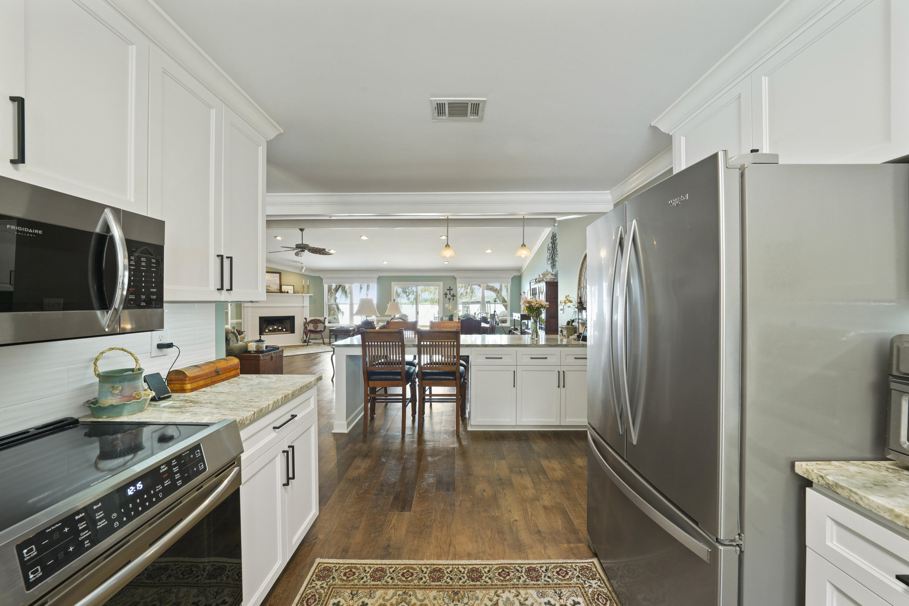94 George Ellis Point Road Freeport, FL 32439 - Photo 14 of 63 a kitchen with a refrigerator and a stove top oven