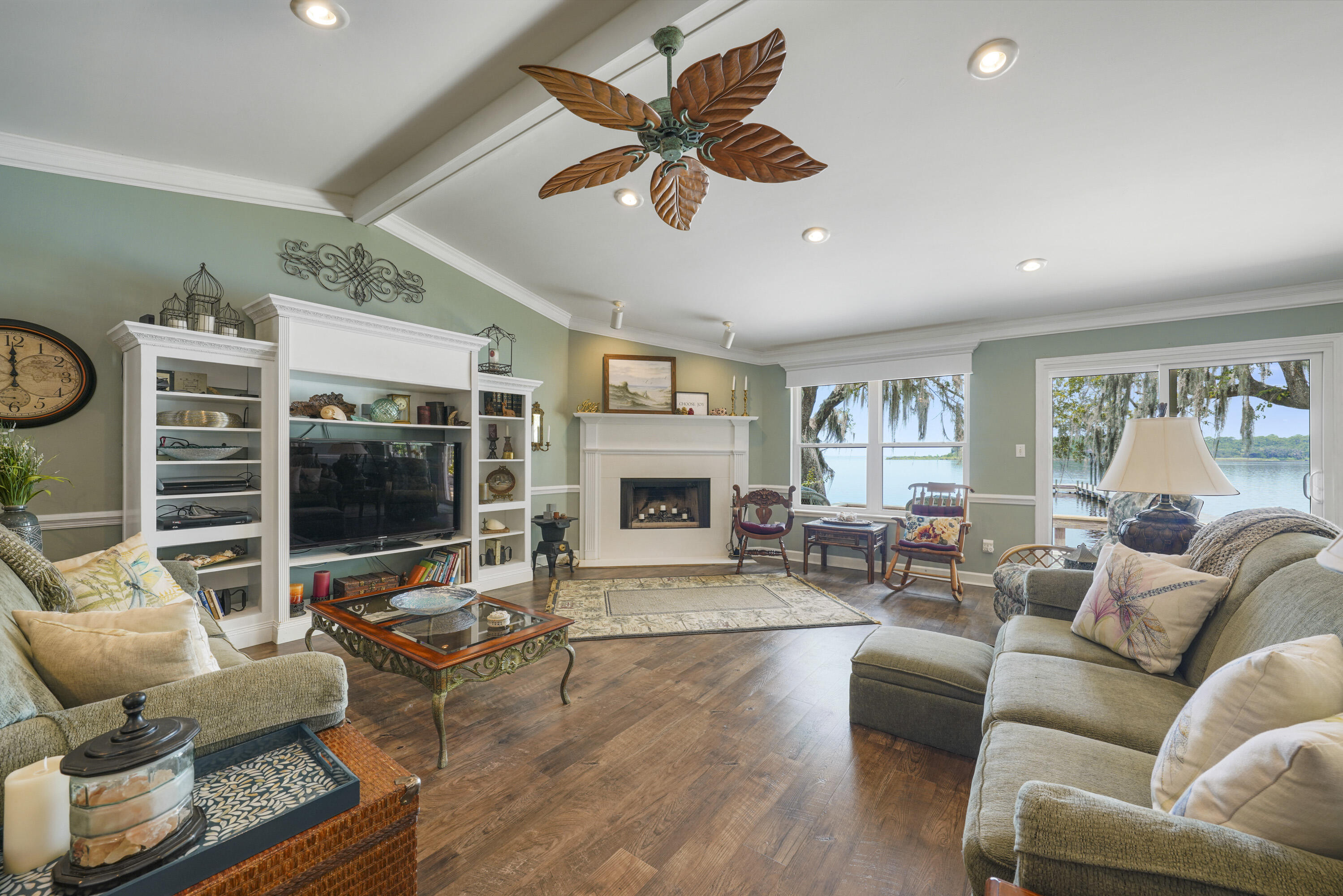 94 George Ellis Point Road Freeport, FL 32439 - Photo 16 of 63 a living room with furniture floor to ceiling window and a flat screen tv