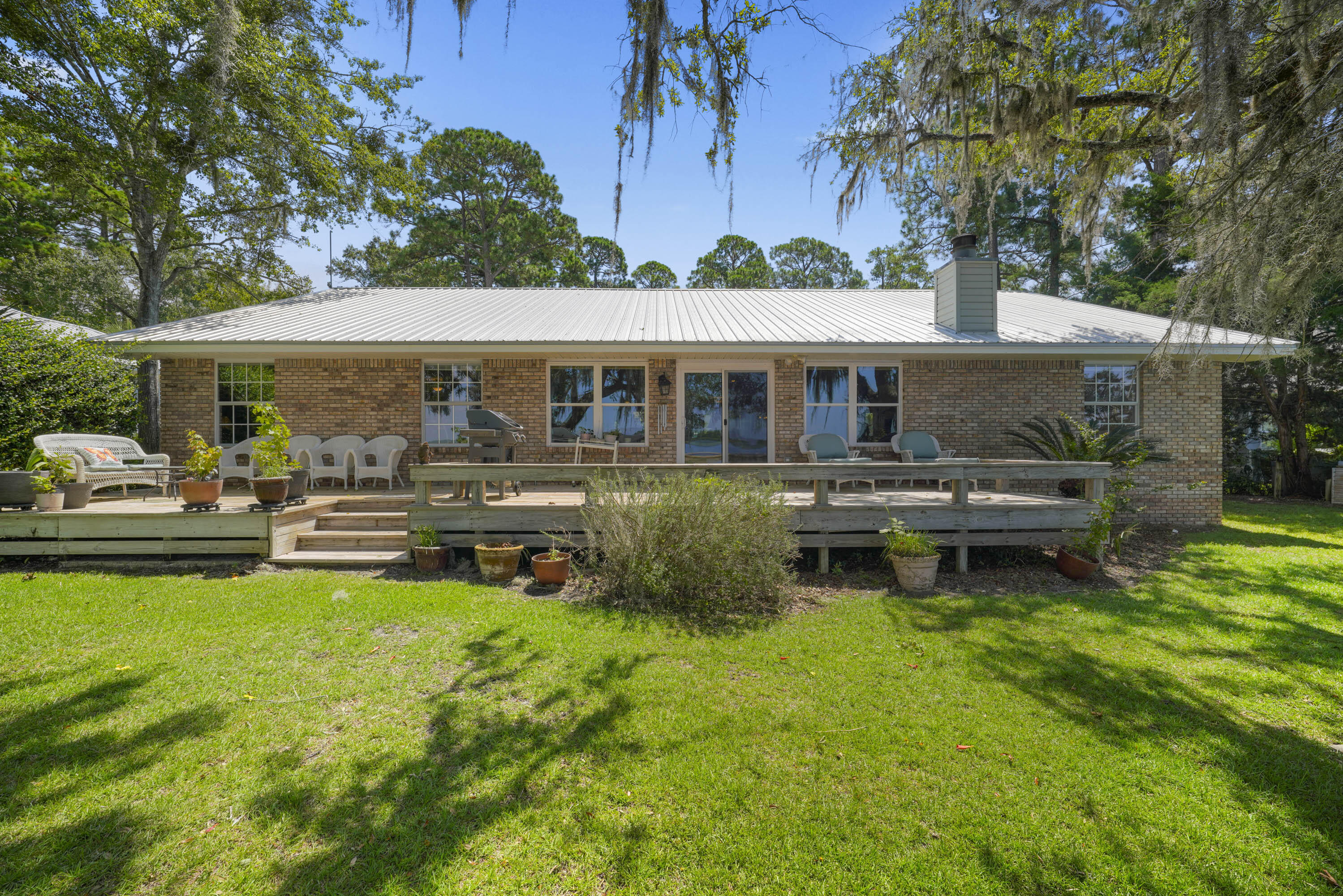 94 George Ellis Point Road Freeport, FL 32439 - Photo 22 of 63 a backyard of a house with yard table and chairs