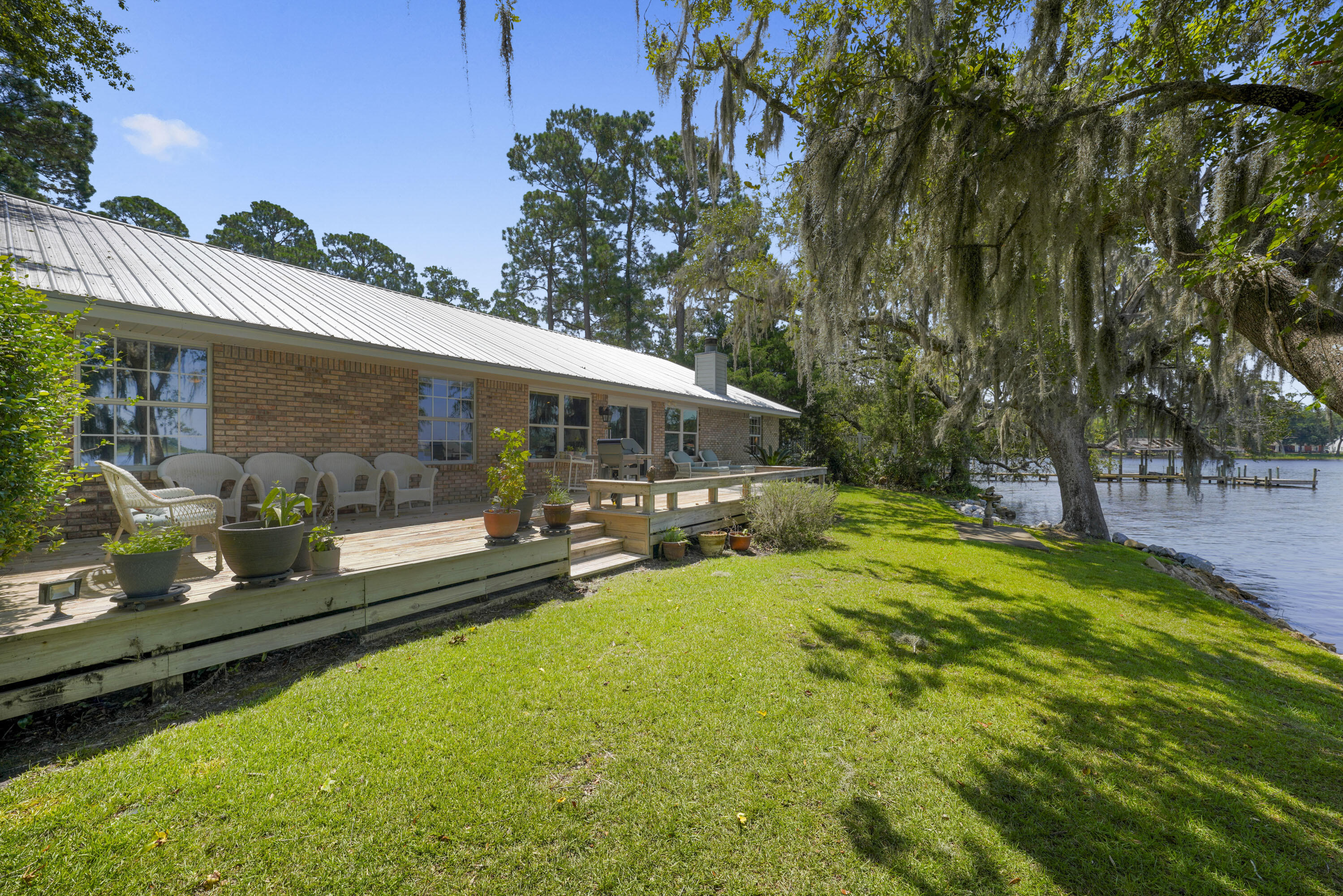 94 George Ellis Point Road Freeport, FL 32439 - Photo 23 of 63 a view of swimming pool with lawn chairs and plants