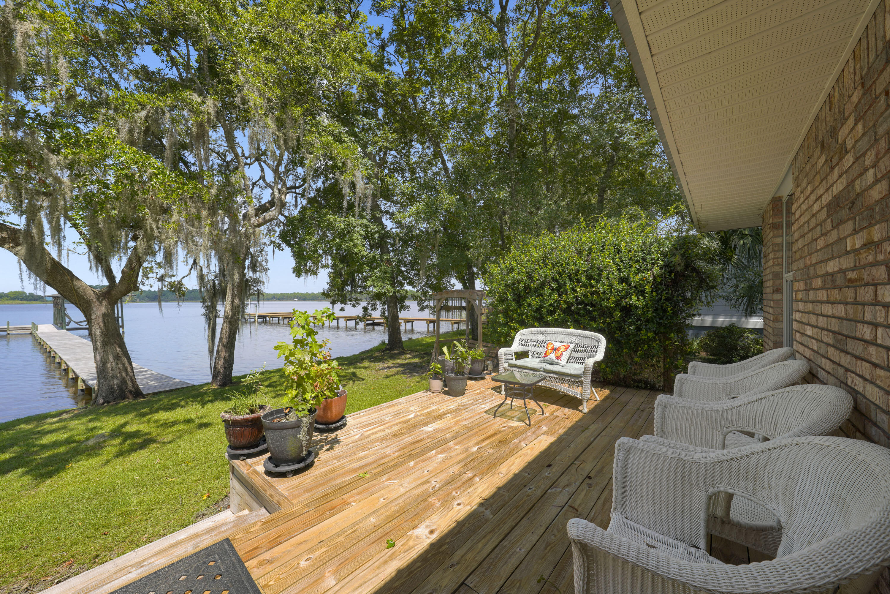94 George Ellis Point Road Freeport, FL 32439 - Photo 29 of 63 a view of a backyard with table and chairs potted plants and large tree