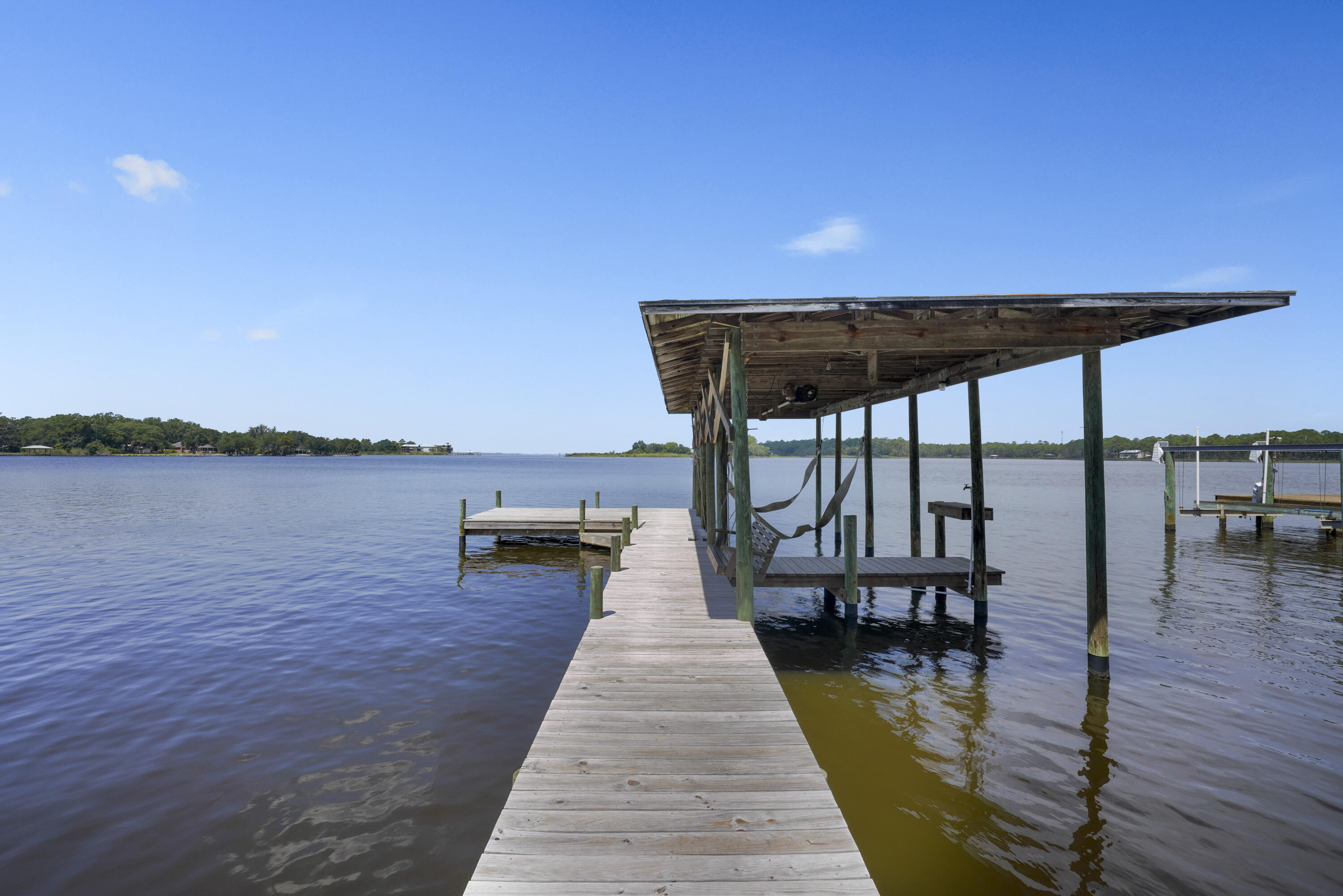 94 George Ellis Point Road Freeport, FL 32439 - Photo 32 of 63 a view of a patio with wooden floor and lake view
