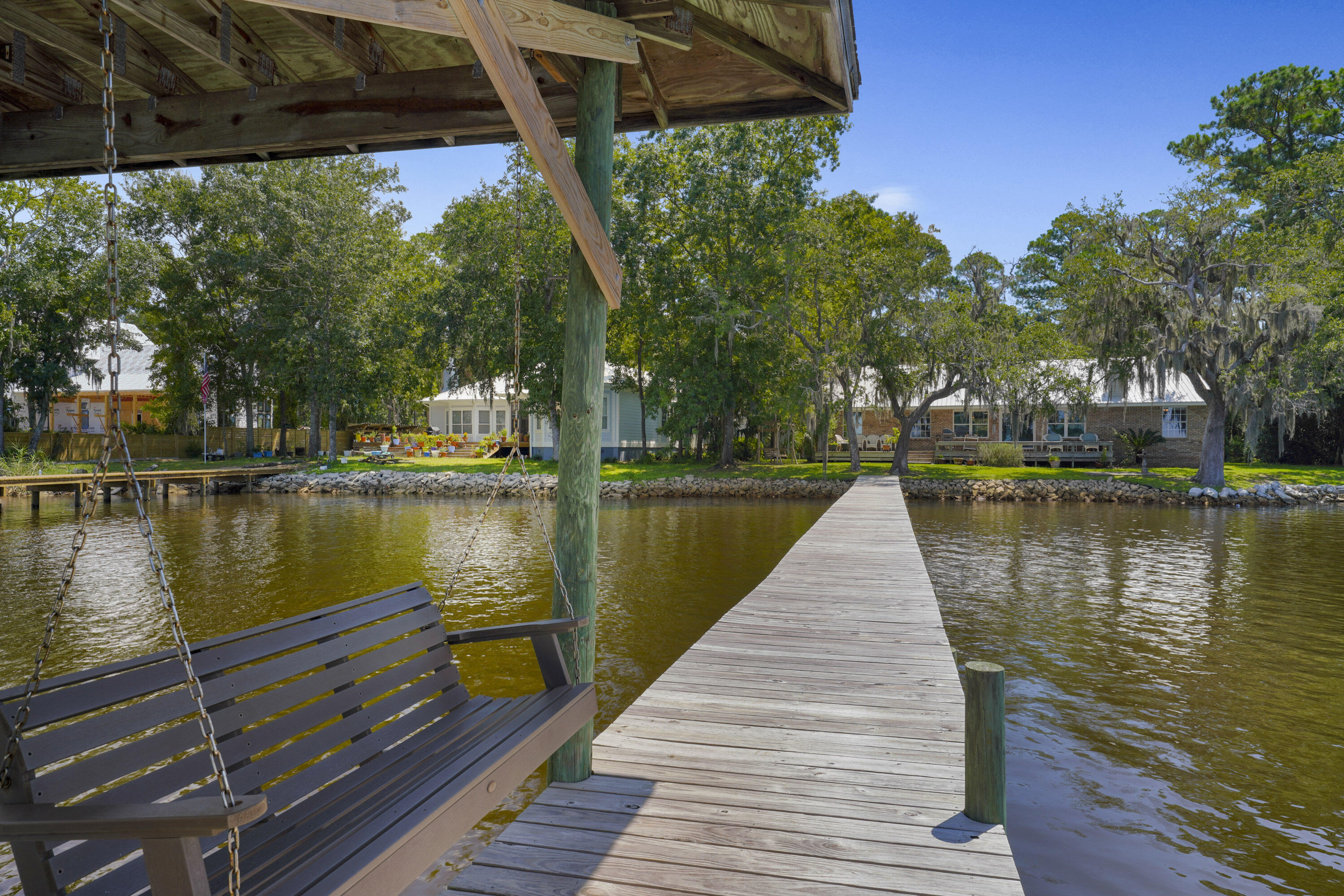94 George Ellis Point Road Freeport, FL 32439 - Photo 35 of 63 a view of a lake with a wooden bridge