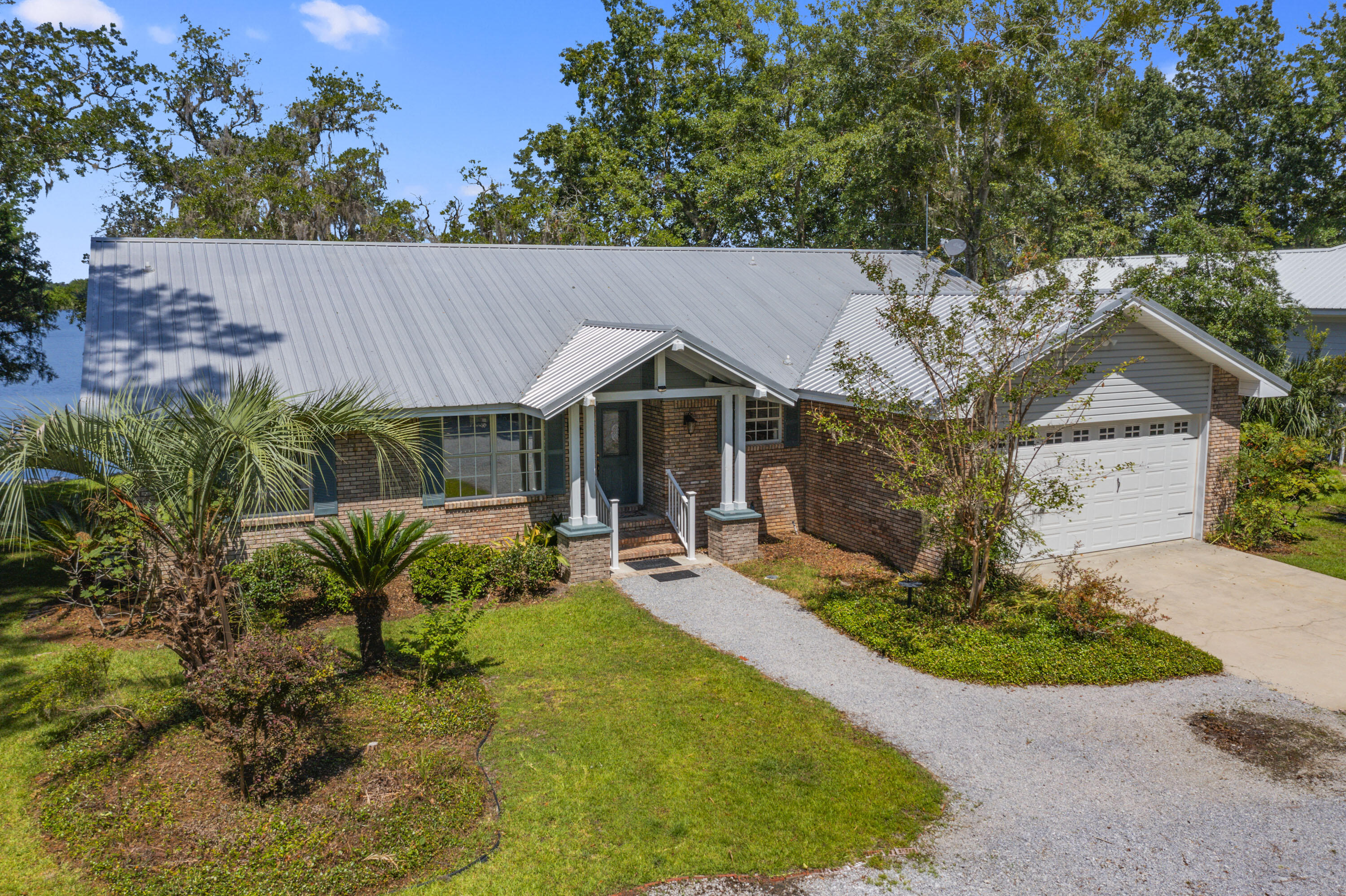 94 George Ellis Point Road Freeport, FL 32439 - Photo 5 of 63 a view of a house with chair and garden