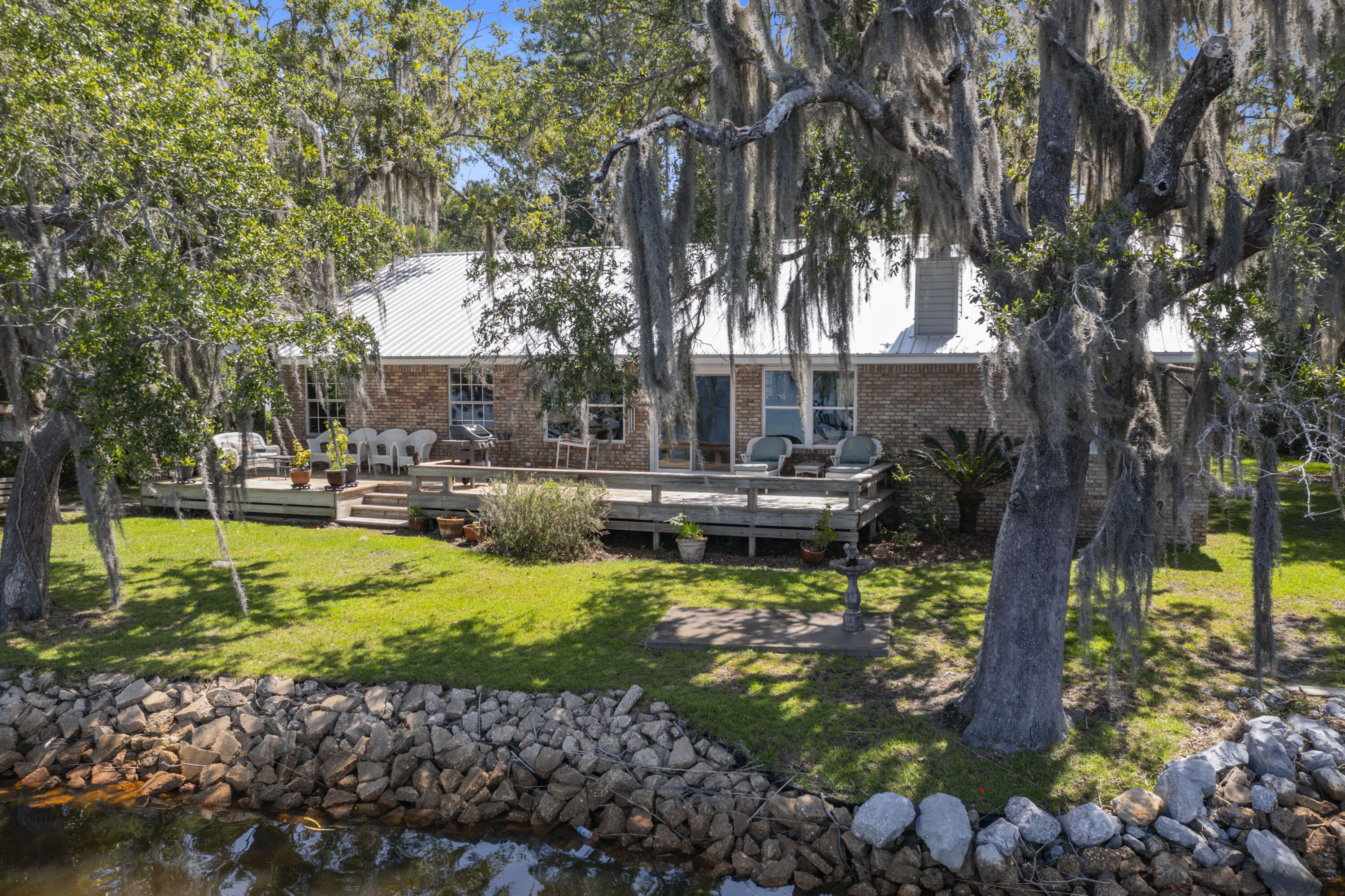 94 George Ellis Point Road Freeport, FL 32439 - Photo 56 of 63 a view of swimming pool with lawn chairs and plants