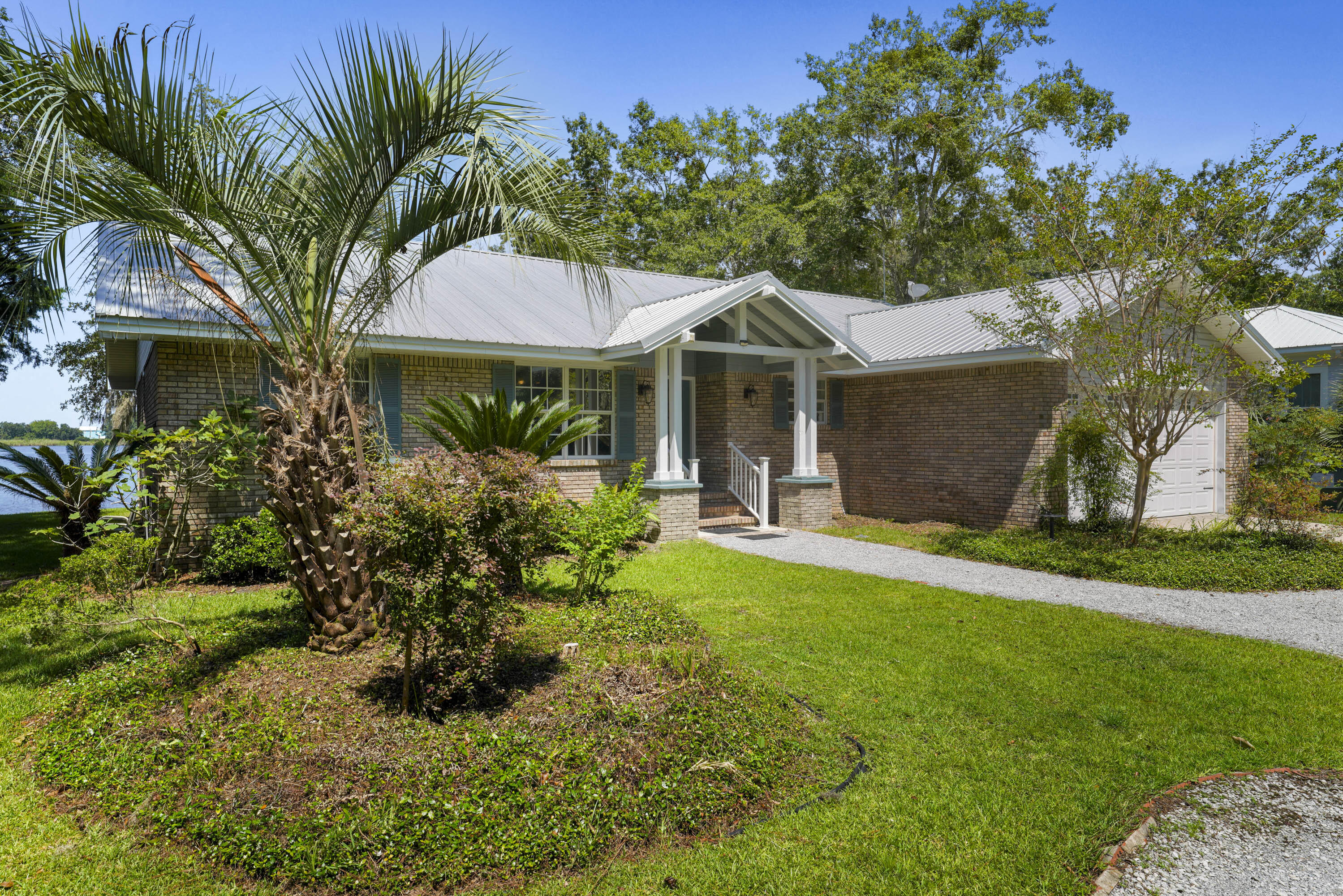 94 George Ellis Point Road Freeport, FL 32439 - Photo 6 of 63 a front view of a house with a garden