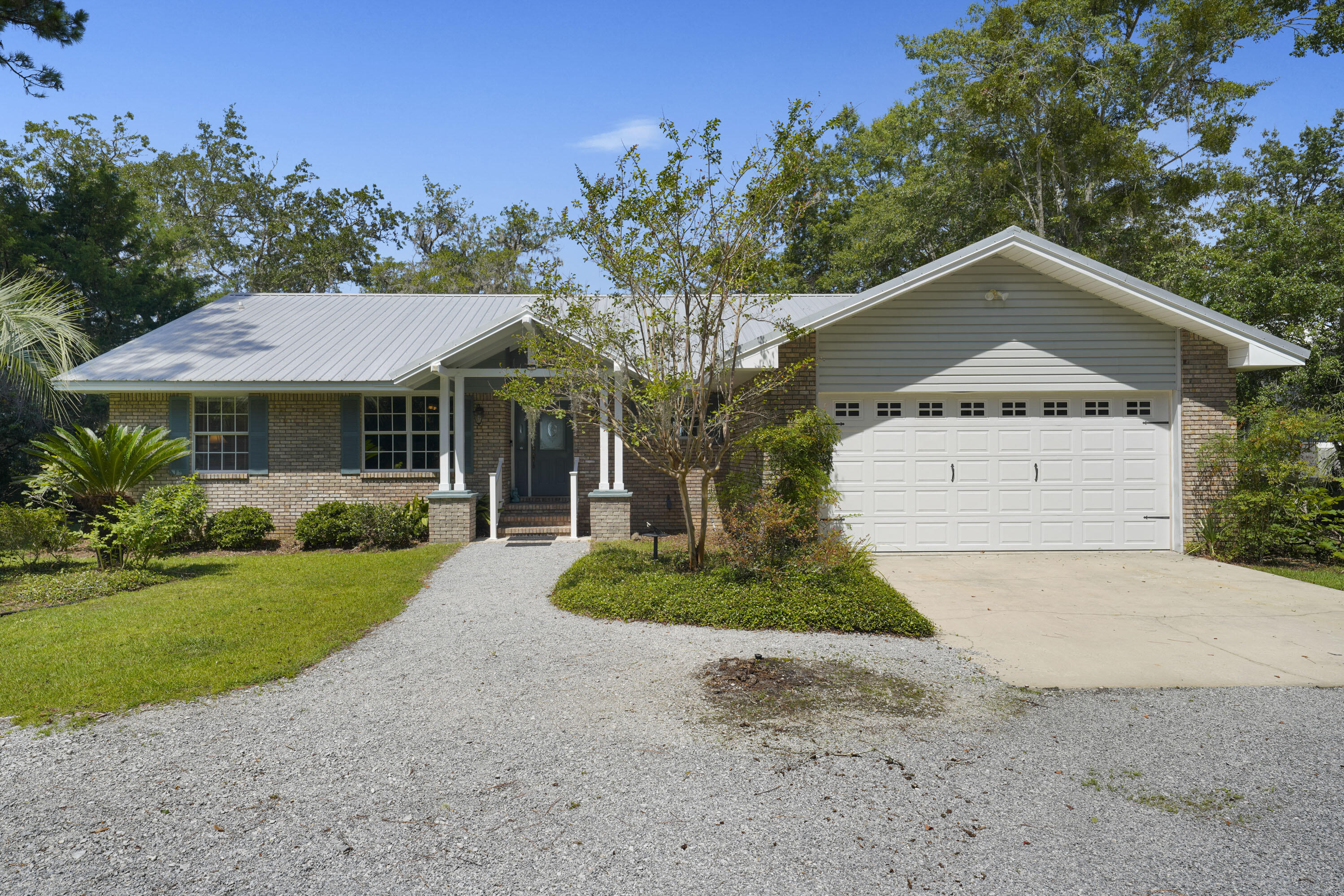 94 George Ellis Point Road Freeport, FL 32439 - Photo 7 of 63 a front view of a house with a yard and garage