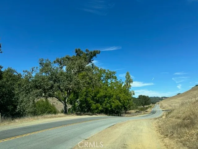 a view of a yard with a house in the background