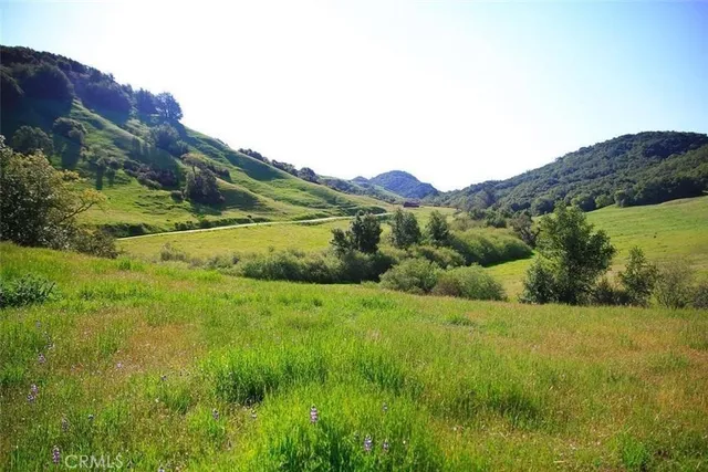 a view of an mountain with grassy field