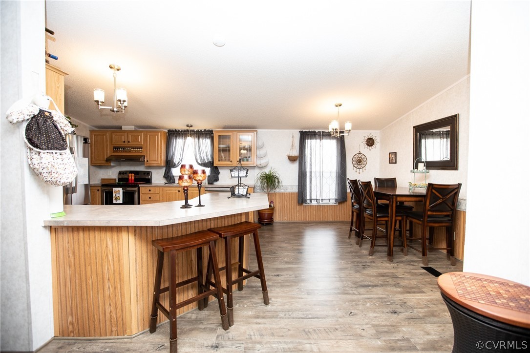 253 Rhodies Road Prospect, VA 23960 - Photo 15 of 38 a kitchen with stainless steel appliances kitchen island granite countertop a table chairs and a refrigerator