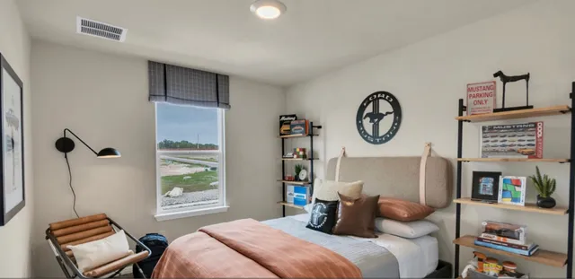 a bedroom with a bed and a wall painting