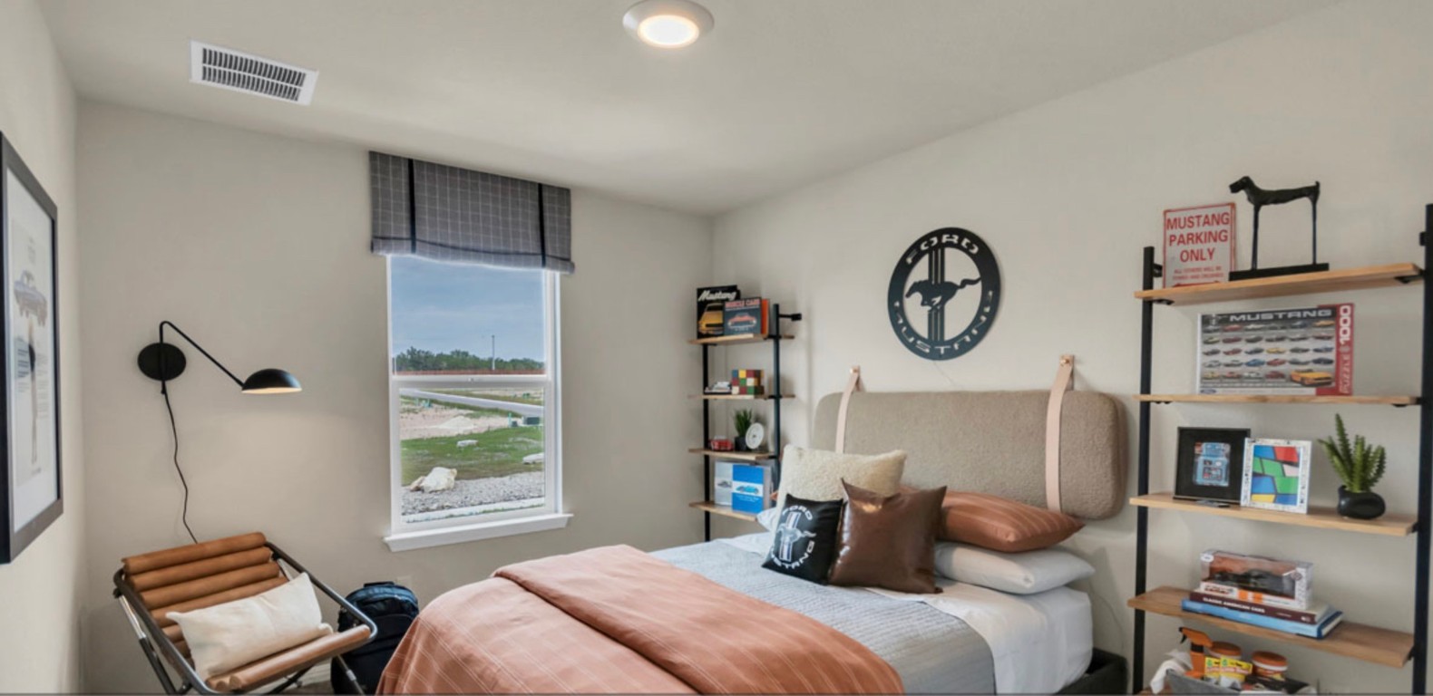 257 Frogmore Loop Kyle, TX 78640 - Photo 10 of 20 a bedroom with a bed a window and a chandelier