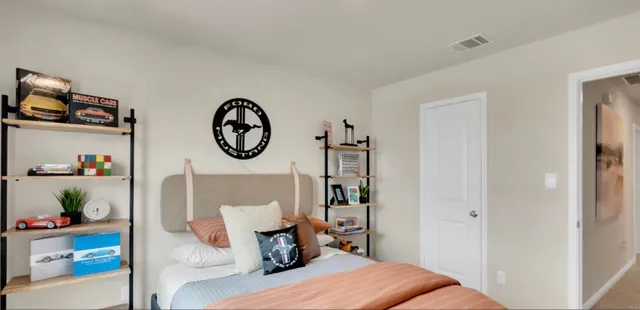 a bedroom with a bed a window and a chandelier