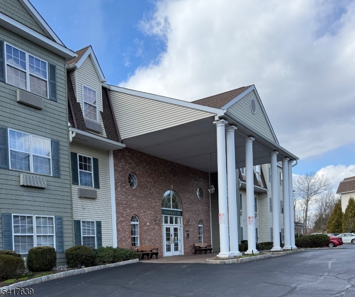 5301 Richmond Road, Unit 301 West Milford, NJ 07480 - Photo 2 of 33 a view of a brick building with many windows