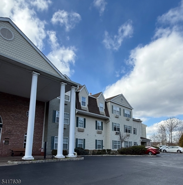 5301 Richmond Road, Unit 301 West Milford, NJ 07480 - Photo 26 of 33 a city street lined with buildings and cars