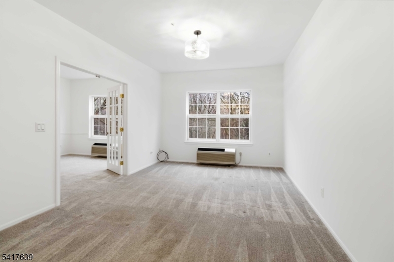 5301 Richmond Road, Unit 301 West Milford, NJ 07480 - Photo 8 of 33 an empty room with windows