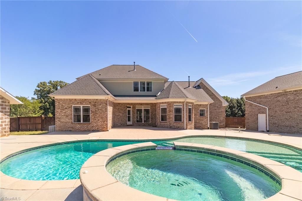 8204 Brotherstwo Road Colfax, NC 27235 - Photo 13 of 50 Hot tub with waterfall feature into heated pool